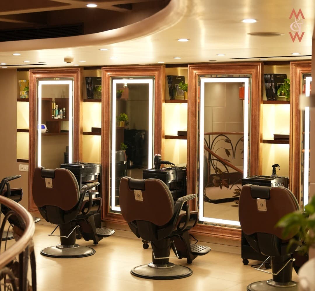 The styling floor at Mirrors & Within, ringed with gold-lit mirrors